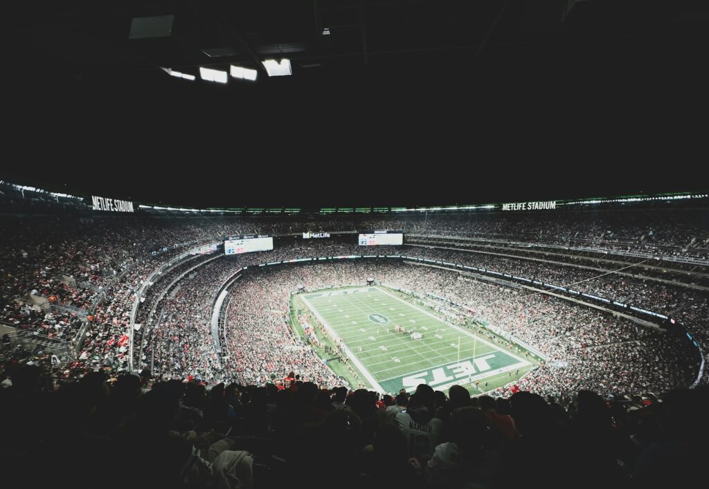 a stadium filled with lots of people watching a football game